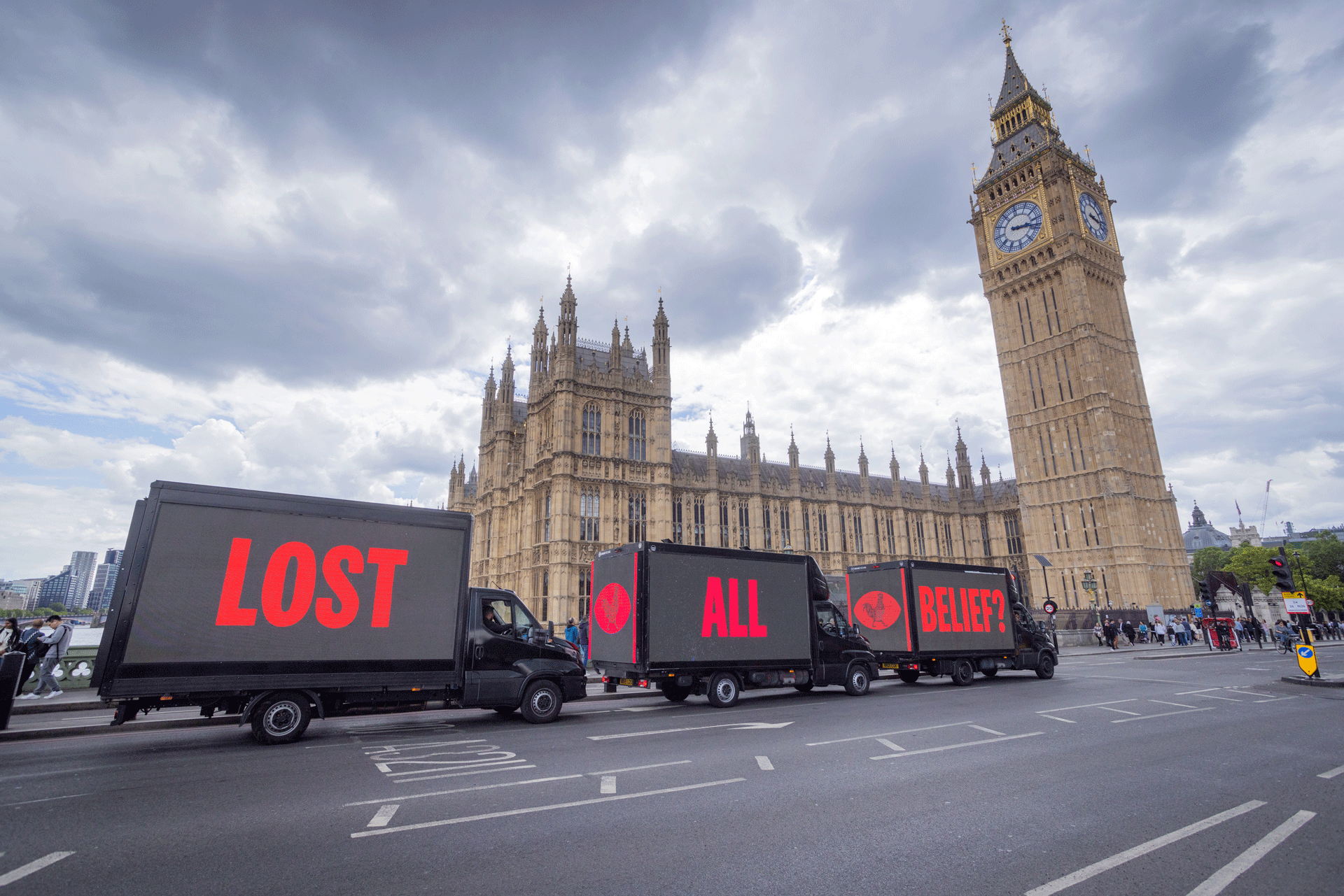 KFC's igital display vans parked outside the Houses of Parliament showing the slogan 'lost all belief?'