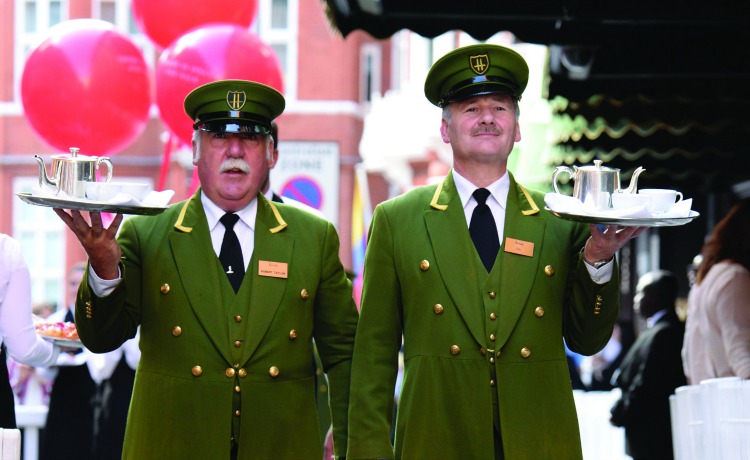 Harrods stays true to its British identity by continuing traditions like its 'Green Men' greeters